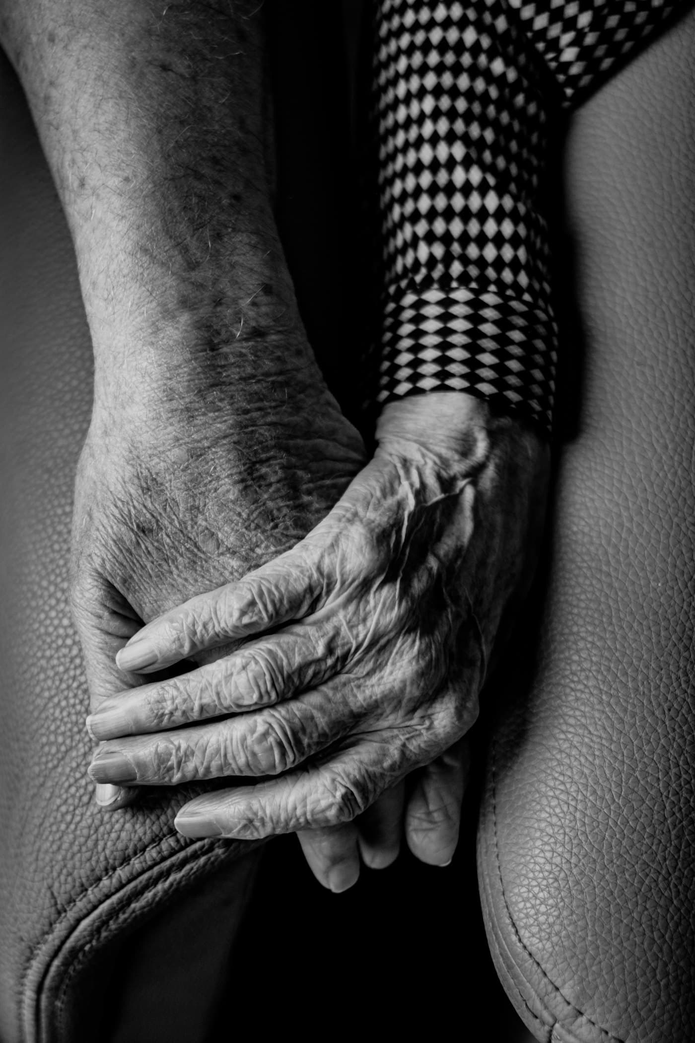 An older person's hands resting in their lap