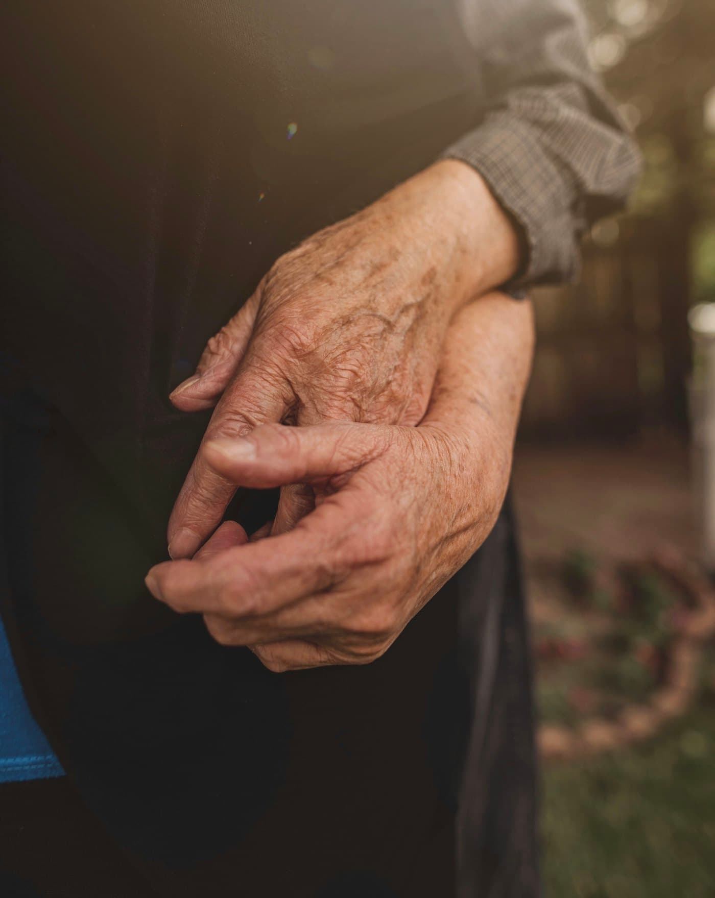 An older couple holding hands